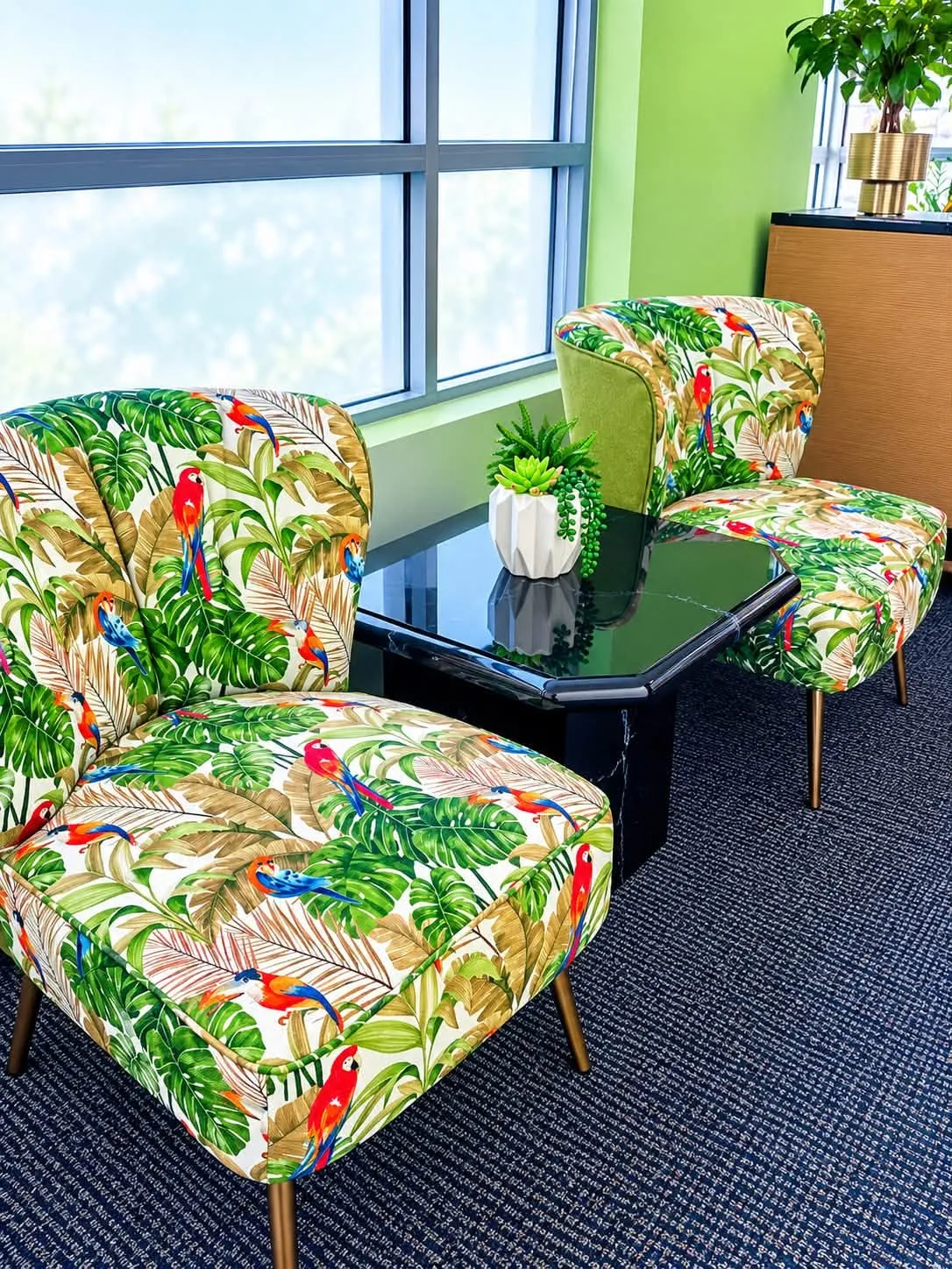 Floral armchairs beside the waiting area window